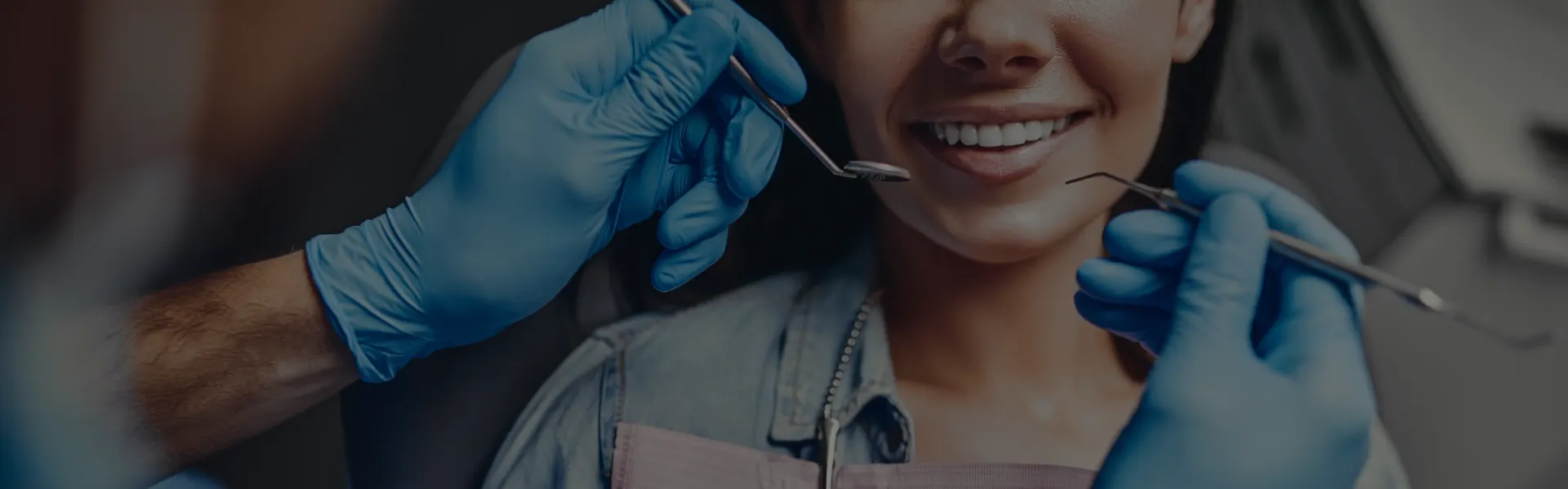 Dentist examining a smiling patient in the dental chair