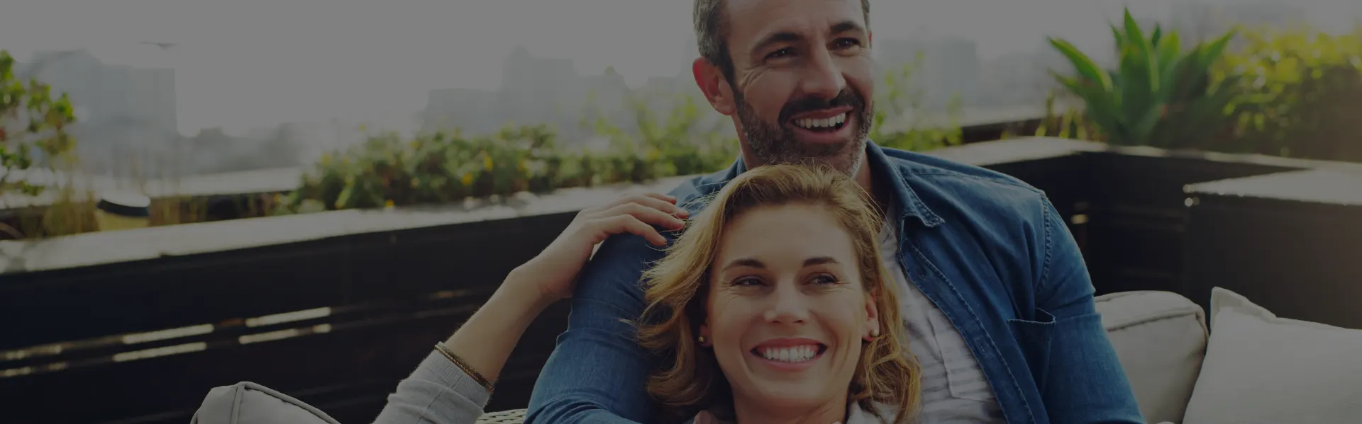 Couple smiling together on a rooftop