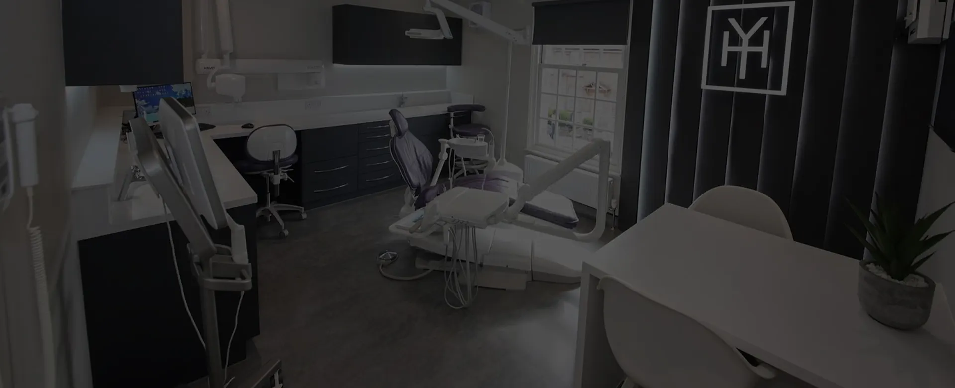 Treatment room at York House Dental Practice in Chesham, with the YH monogram on the wall