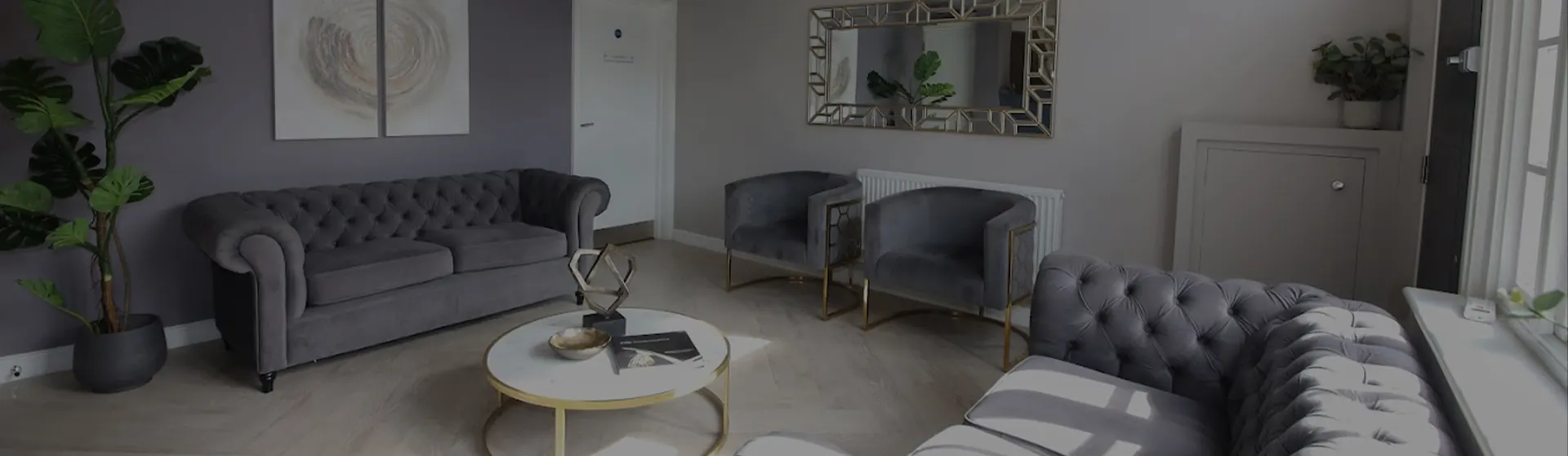 Patient lounge at York House Dental Practice with velvet sofas