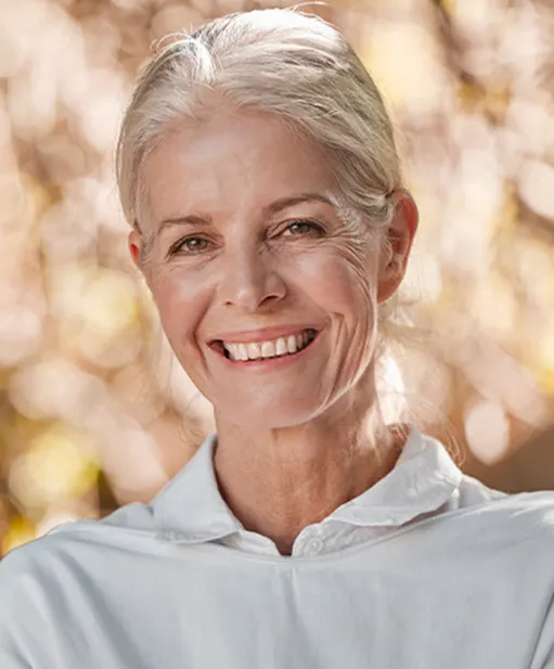 Older woman with grey hair smiling